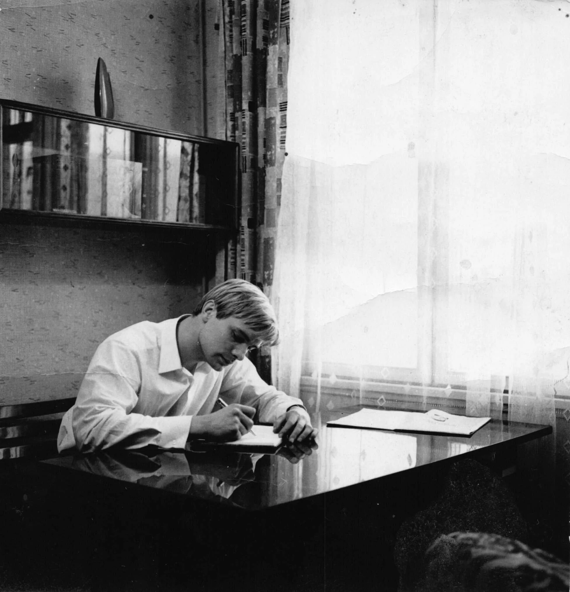 Oleg Vidov writing at his desk