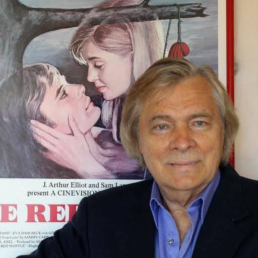 Oleg Vidov in front of a film poster